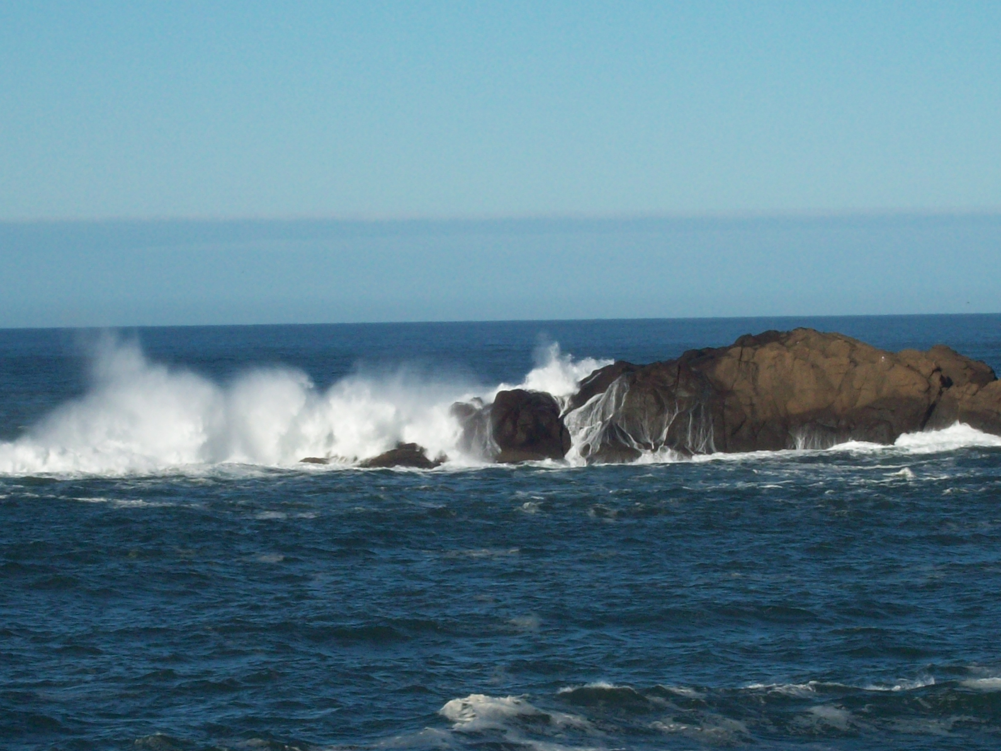 Waves crashing on the rocks.